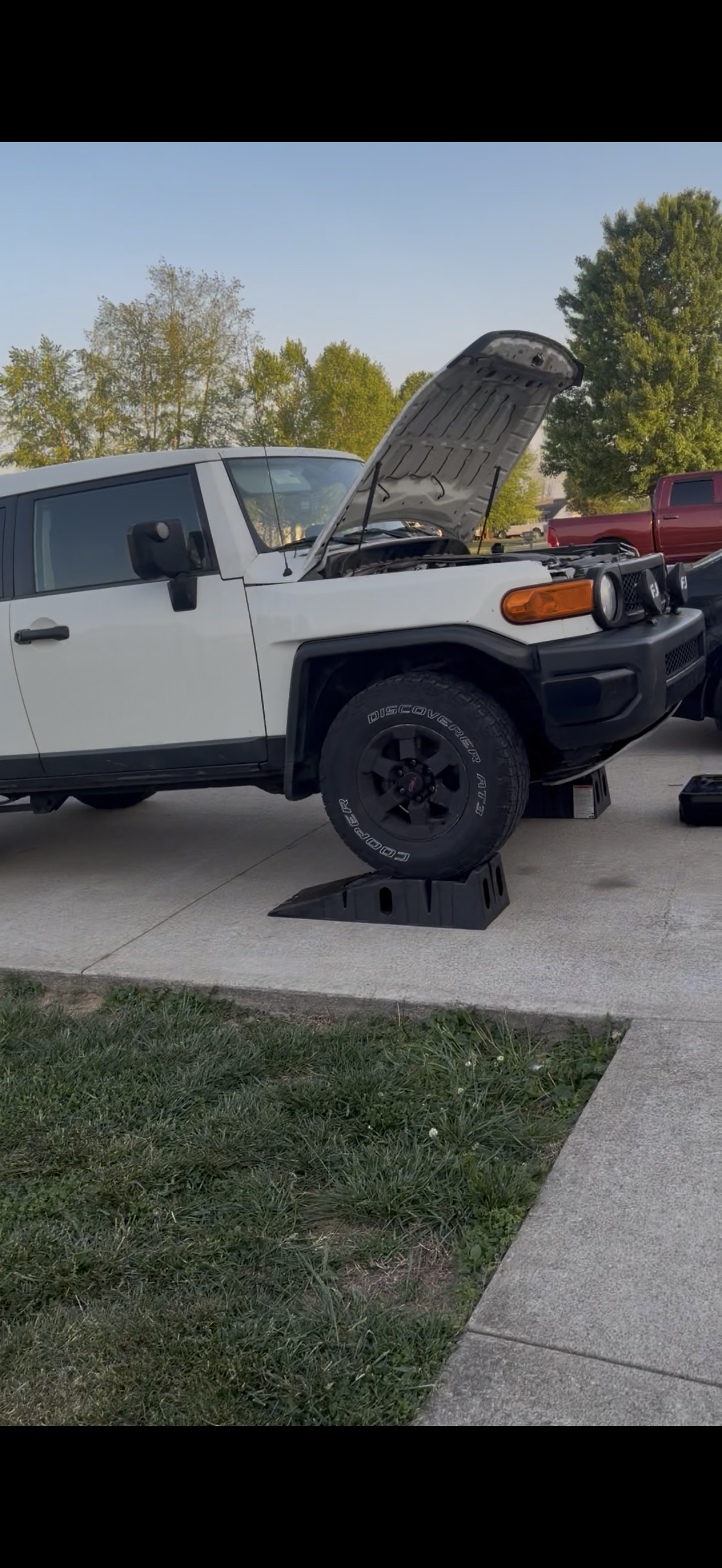White Toyota FJ Cruiser receiving mobile oil change service